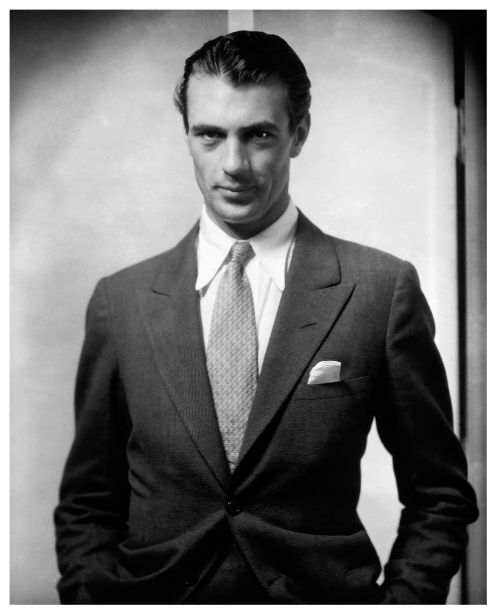 American actor, Gary Cooper looking into camera wearing a suit and tie